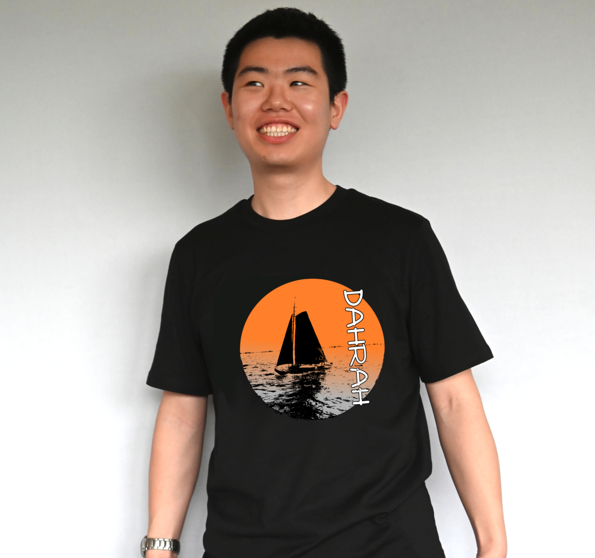 Dahrah Darah unisex organic cotton T-shirt with print of a sailboat in a lake.