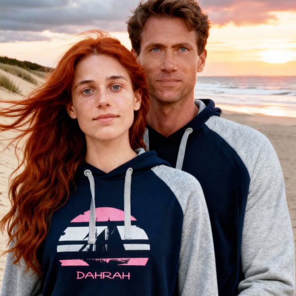 Beautiful couple wearing sailing hoodie with print of Flying Dutchman sailboat, nautical style in grey and navy colors and raglan sleeves.