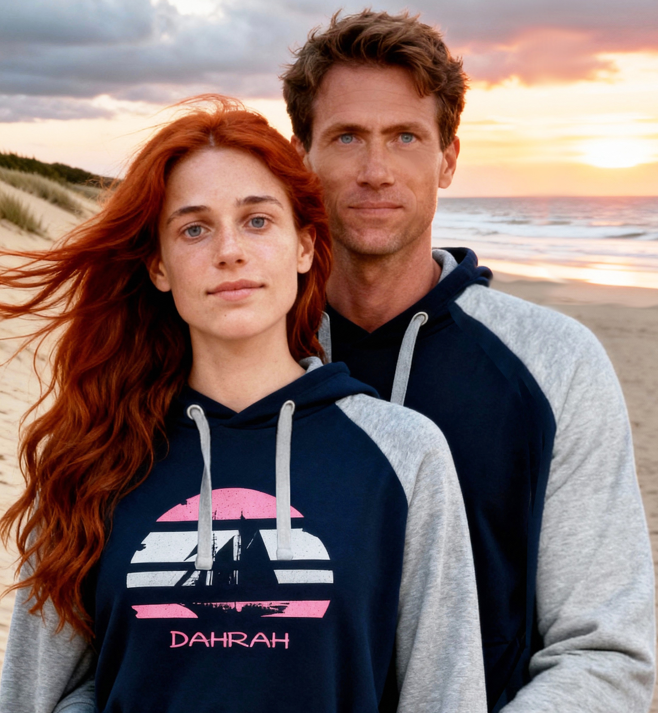 Beautiful couple wearing sailing hoodie with print of Flying Dutchman sailboat, nautical style in grey and navy colors and raglan sleeves.